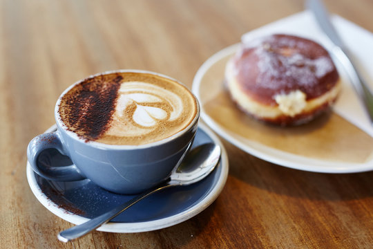 Close-up of aromatic cappuccino with donut
