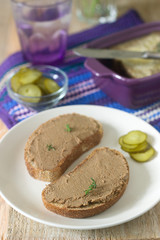 Homemade liver pate with bread and canned cucumber. Rustic style, selective focus.