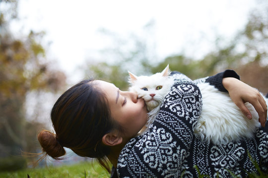 Happy Young Asian Woman With Her Cat Outdoor