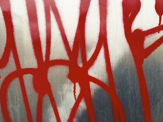 Colorful graffiti markings on metallic wall, close up