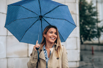 Beautiful woman enjoying a walk on a rainy day.