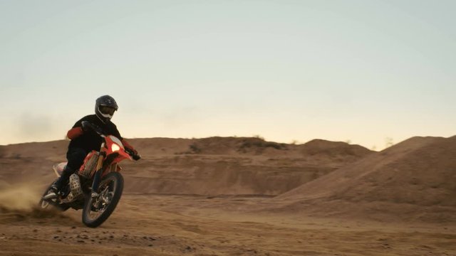 Professional Motocross Biker Drives His Motorcycle on the Off-Road Sand Track.  Shot on RED EPIC-W 8K Helium Cinema Camera.