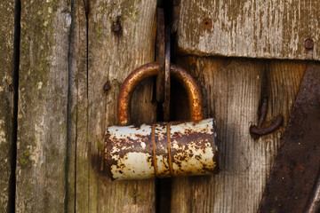 Rusty old lock on the wooden door