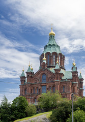 Beautiful vertical view of Uspenski Cathedral in central Helsinki, Finland, under a dramatic sky