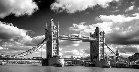 Tower Bridge spanning the River Thames with a dramatic cloudy sky