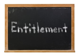 Obraz premium Entitlement written in white chalk on a black chalkboard isolated on white