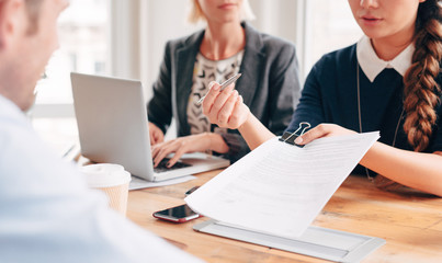 Close up businesswoman hands pointing to legal document for signing