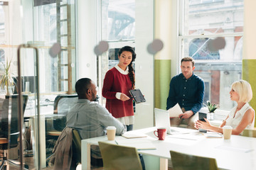 Business meeting at work at trendy startup company presenting pitch for growth and development