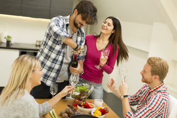 Group of young people drinking wine in the room