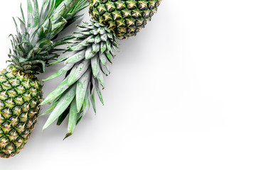 Tropical fruits background. Pinneapple on white top view copyspace