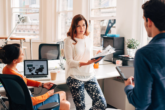 Business meeting at work at trendy startup company presenting pitch for growth and development