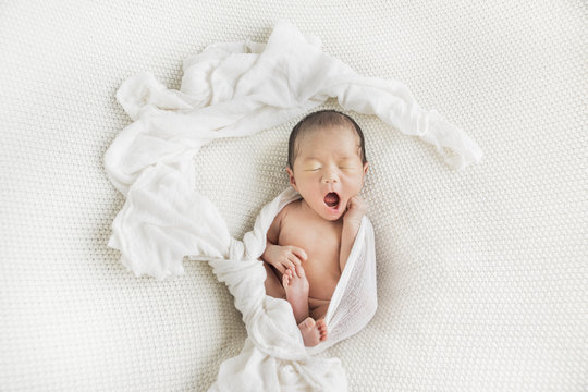 Simple portrait of a yawning newborn baby