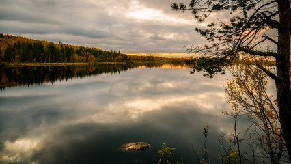 Lake at sunset in autumn forest