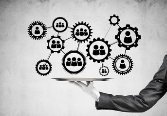 Waiter hand with white gloves holding silver plate full of social media communication icons