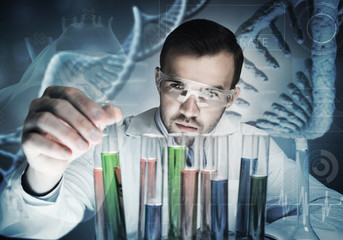 Portrait of concentrated male scientist working with reagents in laboratory