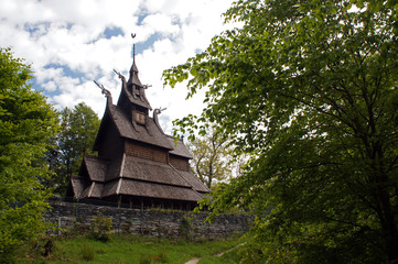 Fantoft Stavkirke - wooden church near Bergen, Norway, surrounded by trees, viking architecture