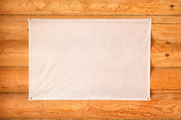 empty flag of cloth hanging wooden blockhouse wall made of cylindered logs