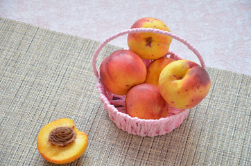 nectarines and peaches in backet. peach, nectarine cut in half stone