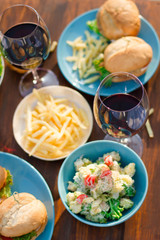      Hands Friends toasting red wine glass and having fun outdoors.