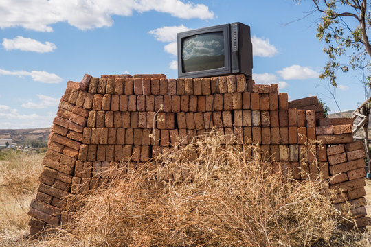 Vintage TV on top of pile of bricks
