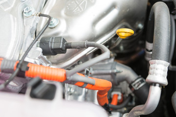 Fototapeta premium Parts of the engine of a hybrid car powered both by electric battery and gas