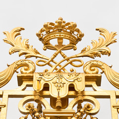 Fototapeta na wymiar The golden gate of the Palace of Versailles, or Chateau de Versailles, or simply Versailles, in France