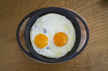 fried egg on wooden table