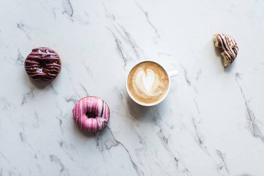 coffee and donuts on a marble background