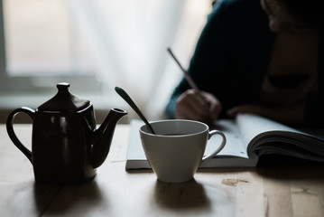young woman writing at her desk