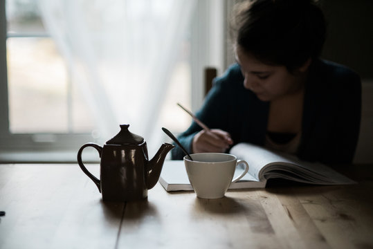 Young woman writing in a notebook
