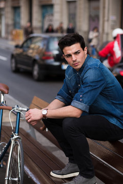 Man in blue shirt outdoors with classic bike