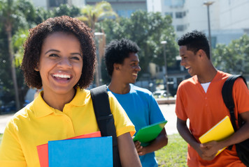 Laughing african american female student with group of other students