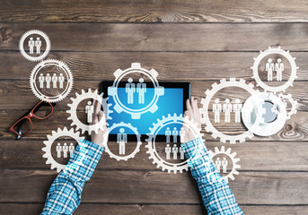 Concept of teamworking and connection with gears mechanism and tablet pc