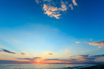 Naklejka na ściany i meble Sunset sky on sea beach