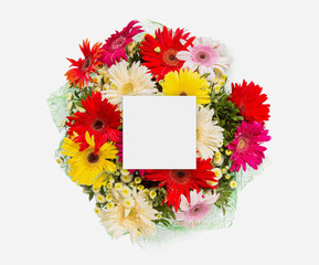 Creative layout made of flowers and leaves with paper card note. Flat lay