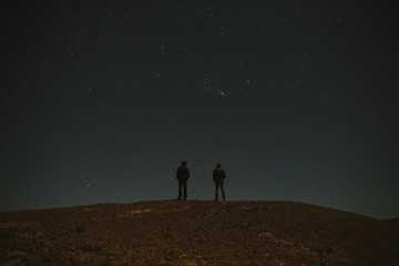 Man standing and looking at stars