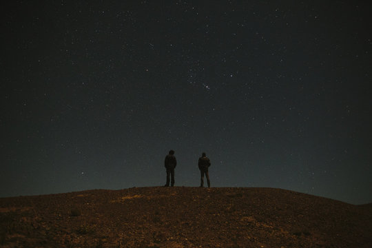 Man standing and looking at stars