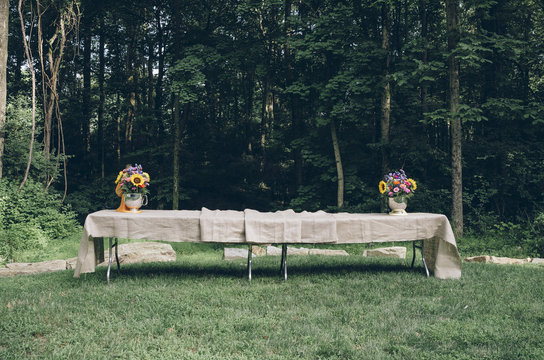 Tables decorated with bouquets and tablecloth for a celebration party