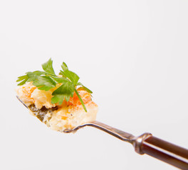 Vegetable salad (potato, carrot, corn, pea, egg, leek) with mayonnaise eaten with a fork