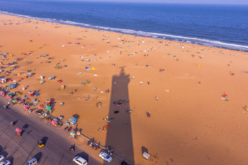 Birds eye view from light house and the shadow of light house, Marina Beach, Chennai. Its longest natural urban beach in India and one of the world's longest beach ranking. - obrazy, fototapety, plakaty