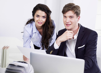 Businessman and businesswoman at desk