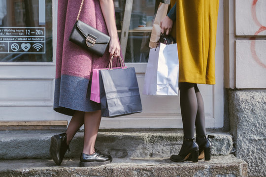 Close up of a Two Women with Shopping Bags Standing in Front of the Shop Window