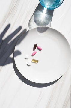 Hand shadow reaching our for medicine