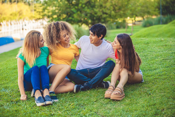 Fototapeta premium Group of happy teenagers in the park having fun spending time