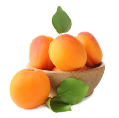 Wooden bowl with fresh apricots on white background