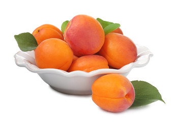Plate with fresh apricots on white background