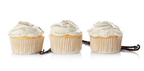 Tasty vanilla cupcakes on white background