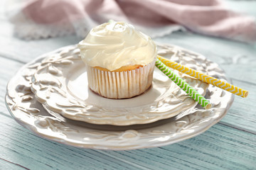 Tasty vanilla cupcake on plates