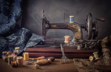 Still life with a sewing machine, scissors, threads - Powered by Adobe