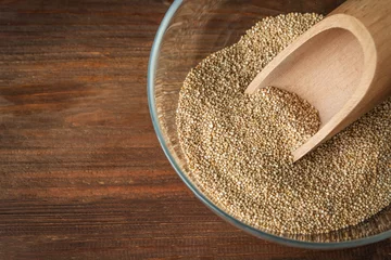 Rolgordijnen Bowl with raw quinoa grains on wooden background © Africa Studio
